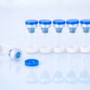 Vaccine vial dose flu shot drug needle syringe,medical concept vaccination hypodermic injection treatment disease care hospital prevention immunization illness disease baby child.blue background