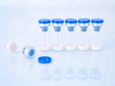 Vaccine vial dose flu shot drug needle syringe,medical concept vaccination hypodermic injection treatment disease care hospital prevention immunization illness disease baby child.blue background