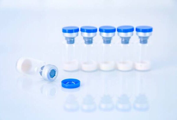 Vaccine vial dose flu shot drug needle syringe,medical concept vaccination hypodermic injection treatment disease care hospital prevention immunization illness disease baby child.blue background